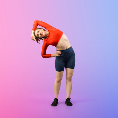 Full body length gaiety shot athletic and sporty young woman with fitness warmup and stretching body for pre exercise posture on isolated background. Healthy active and body care lifestyle.の写真素材