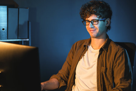 Young businessman reading design thinking on paper for new project surround work desk at neon light modern office. Thinking new next job sketching on notebook before sending present via email. Gusher.の写真素材