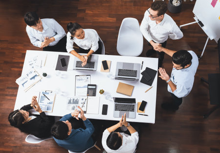 Top view diverse office employee worker shake hand after making agreement on strategic business marketing meeting. Teamwork and positive attitude create productive and supportive workplace. Prudentの写真素材