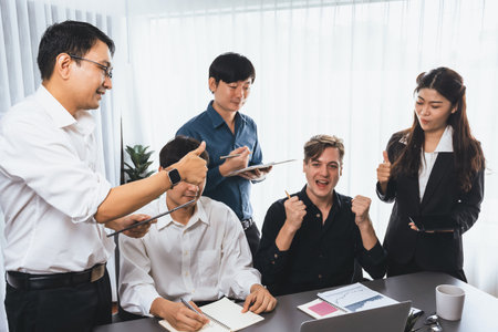 Excited and happy office worker employee celebrate after make successful strategic business marketing planning. Teamwork and positive attitude create productive and supportive workplace. Prudentの写真素材