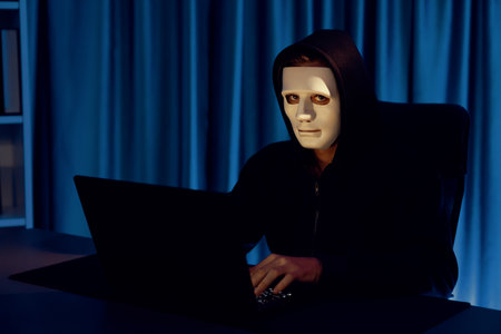 White criminal anonymous mask installing coding password encryption by programming hack, trying to...