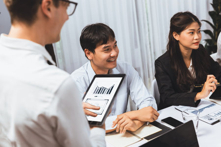 Analyst team utilizing BI Fintech to analyze financial data at table in meeting room. Businesspeople analyzing BI dashboard power on paper for business insight and strategic marketing planning.Prudentの写真素材