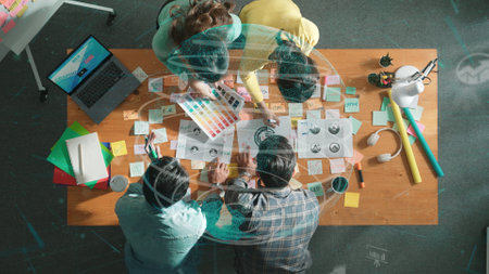 Top view of creative designer working together brainstorming idea by using sticky notes at meeting table with color palettes while talking about global connection and using cloud computing. Symposium.の写真素材