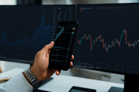 Trader businessman searching on smartphone, analyzing in dynamic stock exchange investment screen on...