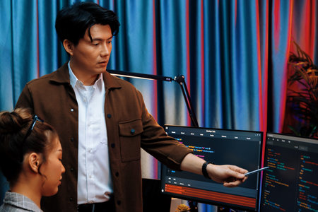 IT developers discussing with point to intelligent website development coder system running data...