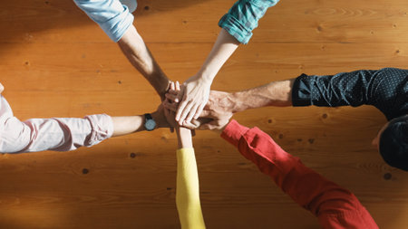 Close up of happy start up business people hand putting hands together at meeting and clapping hand...