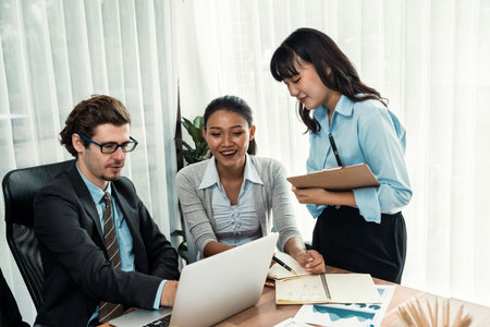 Diverse of business people from various ethnic group working in modern office environment. Productive and multi ethnic office workers engage in discussion for strategic business marketing. Meticulousの写真素材