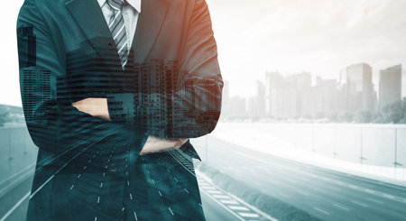 Double Exposure Image of Business Person on modern city background. Future business and communication technology concept. Surreal futuristic cityscape and abstract multiple exposure interface. udsの写真素材