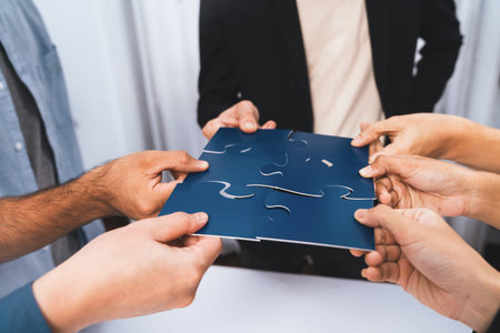 Business team joining jigsaw puzzle together symbolize group of business partnership and strong...