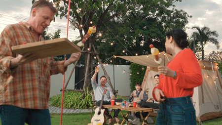 Family all together camp in garden, Old couple grill food for family member. Outdoor camping...