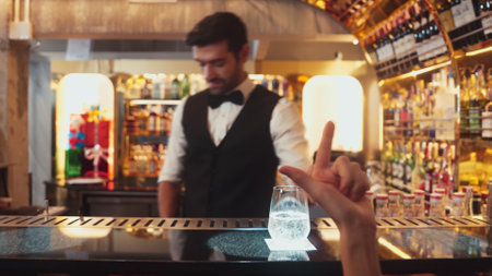 Serving special drink gin fizz of mixed cocktail to smiling VIP customer with couple or friend group by smart bartender service at beverage counter bar luxury nightlife at nightclub party. Vinosity.の写真素材