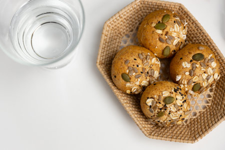 Top view of tasty healthy food in wholegrain bun topping with sunflower seed, oat and wholegrain baked by homemade serving on white table on bakery gourmet bread special menu cafe concept. Infobahn.の写真素材