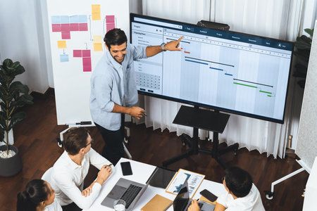 Project manager communicate and collaborate with team using project management software display on...