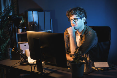Young businessman concentrating on pc for creative startup project job at neon light modern office....