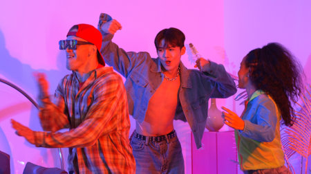 Close up of break dancer team dancing together at modern studio with pink led light. Multicultural people moving to hip hop music while wearing stylish fashion cloth. Crazy, funny mood. Regalement.の写真素材