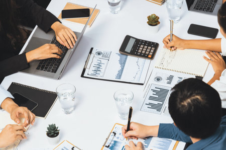 Diverse corporate audit team or company bookkeeper and accountant consultant calculate account expenses and income budget for tax refunds using calculators in busy workspace. Prudentの写真素材