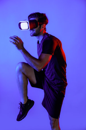 Caucasian smart man jogging while wearing VR goggle with neon light. Happy person with casual cloth...