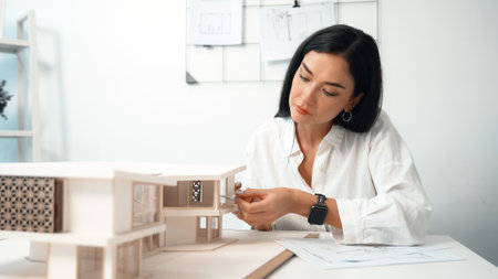 Closeup portrait image of professional young beautiful engineer architect using triangular scale...