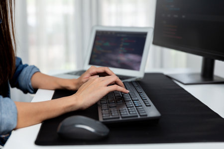Cropped hands image of IT developer creating with typing information on pc with coding program information data website application, wearing jeans shirt surround safety analysis two screen. Stratagem.の写真素材