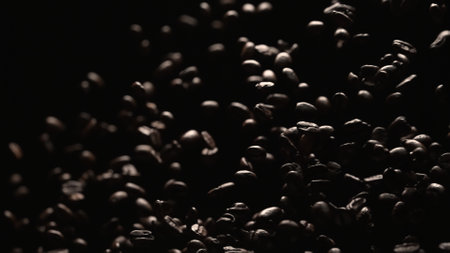 Macro shot of super slow motion shot of fresh coffee bean placed with black background. Close up of...