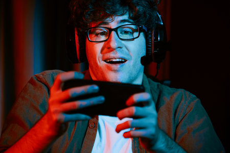 Stressful young gaming streamer team playing with Esport online on smartphone fighting harder game...