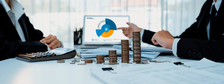 Business intelligence analyst use BI software on laptop to analyze financial data dashboard with growth stack coin symbolize business technology make investment decision in panorama. Shrewdの写真素材
