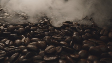 Close up of fresh brown coffee bean with roasted smoke from pile of coffee beans. Macrography of hot coffee seed with fragrant and scented hot smoke come from pile of bean. Top down view. Comestible.の写真素材