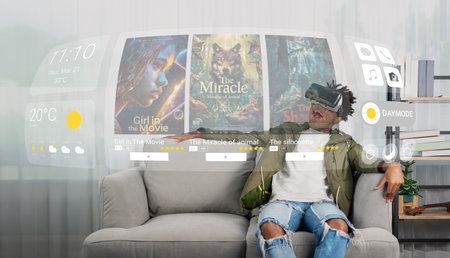 African teenager with VR selecting movie for watching at living room while sitting at sofa....
