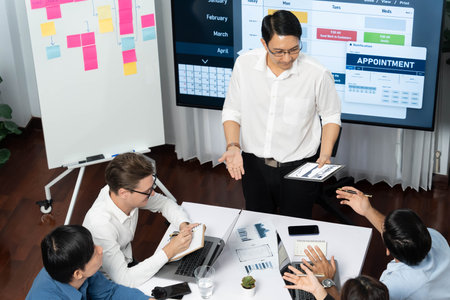 Project manager communicate and collaborate with team using project management software display on...