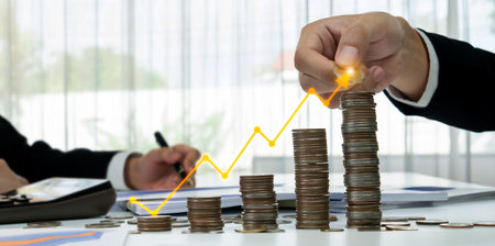 Coin stack with digital graphic indicator symbolizing business investment and economic growth....