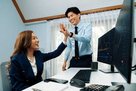 Smiling business partners making high five with profit upper stock market exchange with dynamic rate...