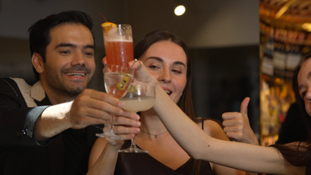 Group friends making a toast with cocktail in martini, margarita, paloma, old fashioned at luxurious...