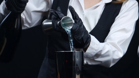 Macrography of skilled bartender hand measure syrup and pour it in to shaker. Close-up of process, highlighting the skill and attention to detail involved in crafting the perfect cocktail. Comestible.の写真素材