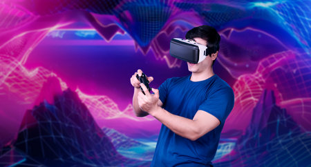 Professional gamer wearing VR headset while holding joystick at pink and purple gradient background....