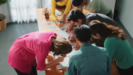 Close up of developer team using mind map to brainstorm idea. Top view of skilled group of business people working together writing marketing strategy by using markers and sticky notes. Symposium.の写真素材