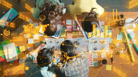 Top down view of business team with casual outfit looking laptop screen and sharing idea. Aerial view of manager works and checking color palette at table with statistic graph holographic. Symposium.の写真素材