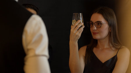 Focusing beautiful customer talking with bartender at back side for looking vodka cocktail with lime...