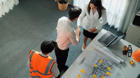 Top view of project manager and civil engineer holding laptop while explain idea to architect....