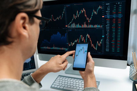 Smart stock investors pointing on screen with smartphone for market stock exchange along with laptop...