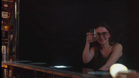 Beautiful woman enjoy drinking special in gin fizz with lemon sliced surrounded by friends in cheers...