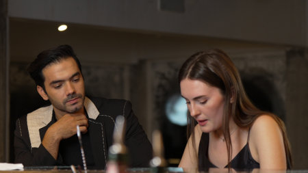 Portrait of focus beautiful woman talking with couple while looking at smartphone with serious face...