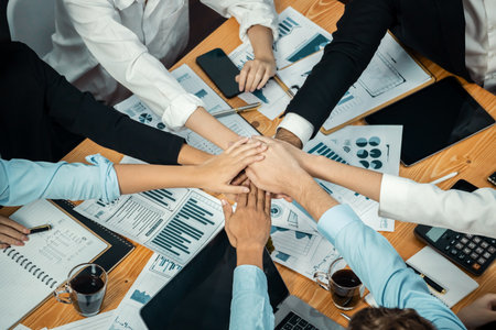 Multiracial business people make synergy hand stack together in meeting room as cooperation or team building for corporate employee in workplace. Top view. Meticulousの写真素材