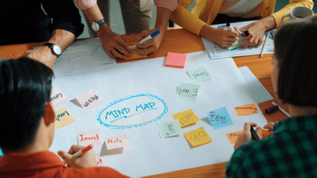 Top view of business team in casual cloth hand writing idea on sticky notes. Closeup of diverse...