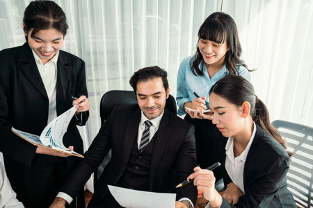 Diverse of business people from various ethnic group working in modern office environment. Productive and multi ethnic office workers engage in discussion for strategic business marketing. Habilimentの写真素材