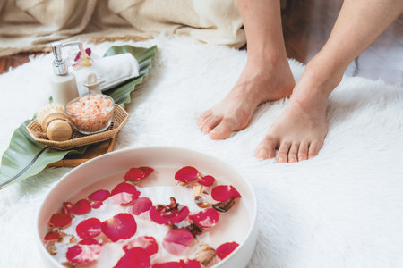 Woman indulges in blissful foot massage at luxurious spa salon while masseur give reflexology therapy in gentle day light ambiance resort or hotel foot spa. Quiescentの写真素材