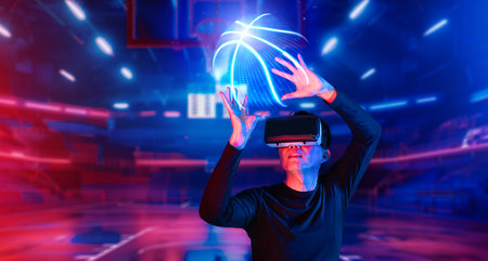 Basketball player holding basketball hologram at futuristic sport arena. Energetic athlete or sport person practicing basketball skill by using augmented reality technology. Innovation. Ingenuity.の写真素材
