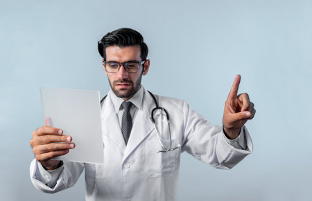 Caucasian smart doctor pointing finger while standing at white background and wearing lab coat....