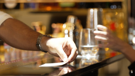 Closeup bartender hand in poring fresh soda gas texture into glass of drink advertisement serving customer at beverage bar counter luxury pub for welcome impression greeting guess service. Vinosity.の写真素材
