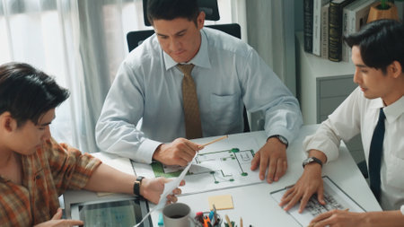 Top aerial view of project manager or civil engineer writing at blueprint and planning building...