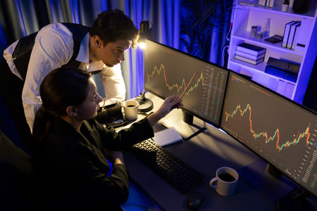 Top view business traders discussing dynamic stock exchange currency rate risk investment, pointing...